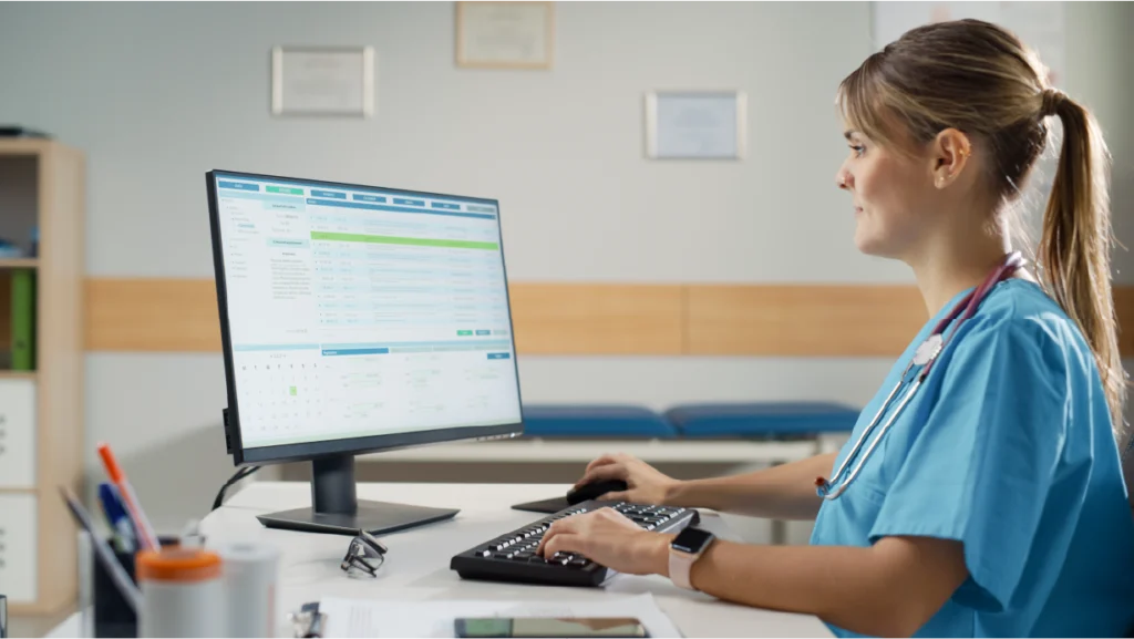 Nurse uses EMR to record patient information