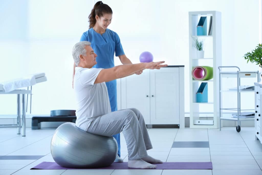 Physical therapist working with an elderly patient