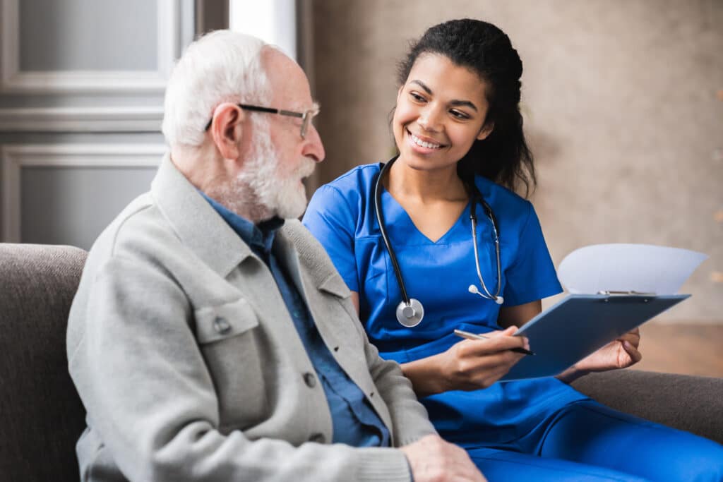 a nurse talks to a man at a skilled nursing facility