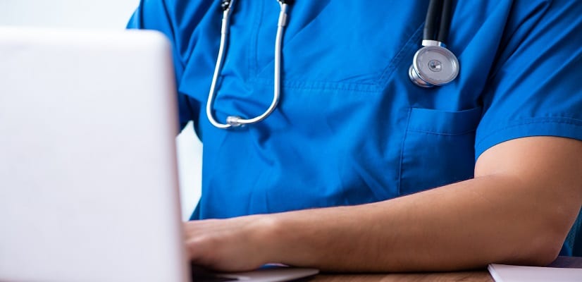 doctor uses healthcare analytics to assess patient care