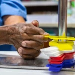 man participates in occupational therapy sliding discs up and down a pole