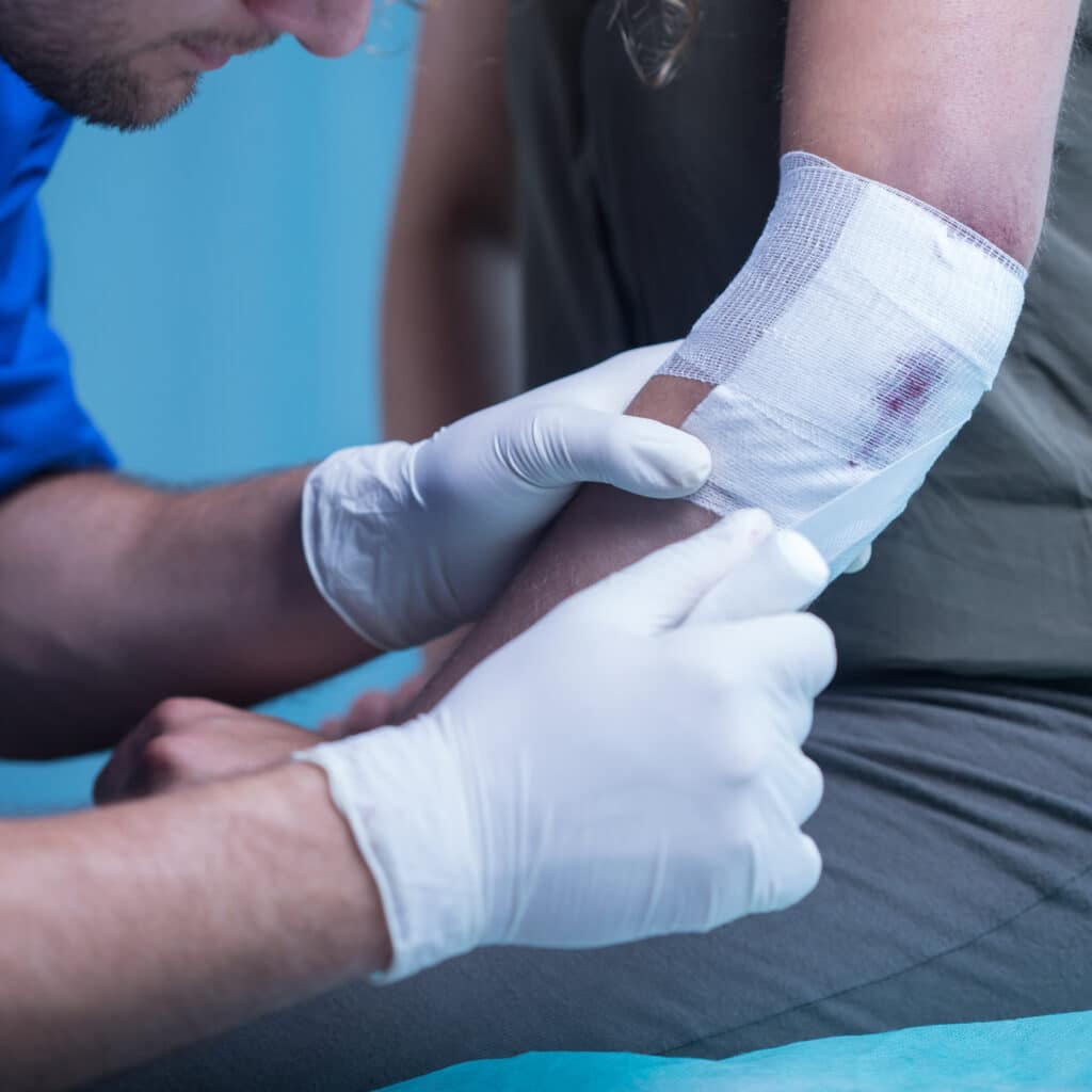 nurse performs wound assessment and dressing