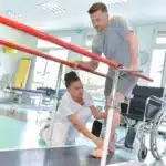 Man practices walking in physical therapy after car accident