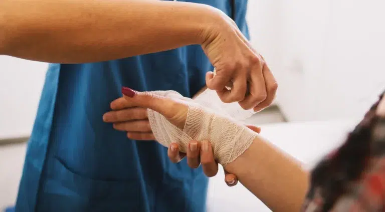 occupational health nurse wraps a patient's wrist